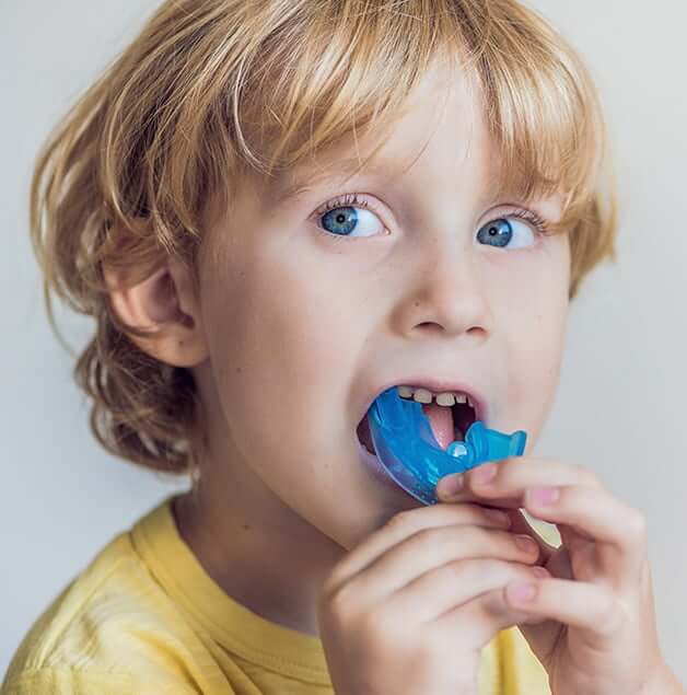 young boy with a mouthguard