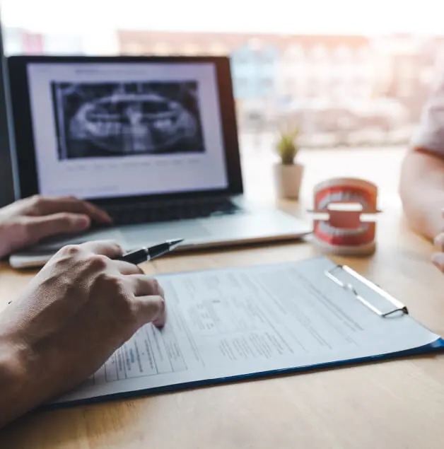 two people discussing dental-related paperwork