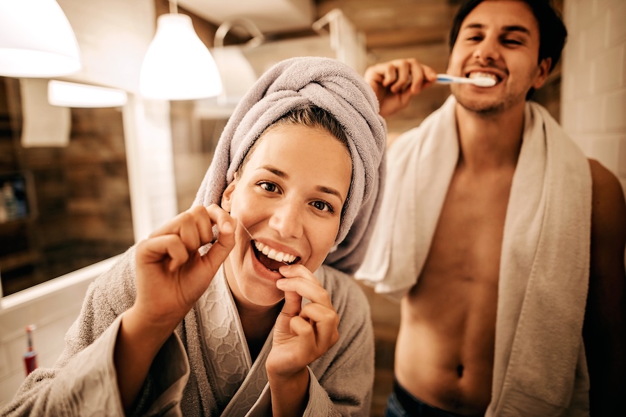 new years resolutions for your smile, couple brushing and flossing for a healthy sile