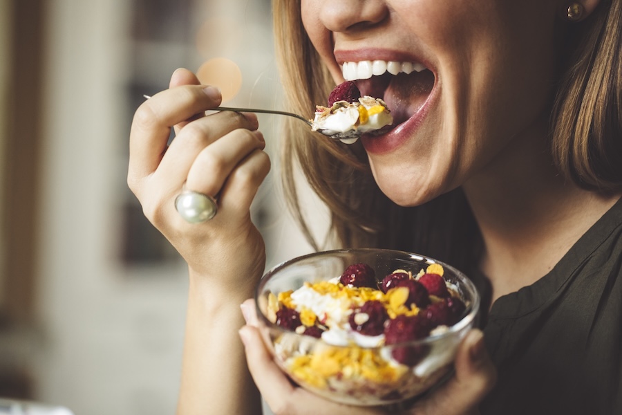 woman eating yogurt for strong teeth with great nutrition