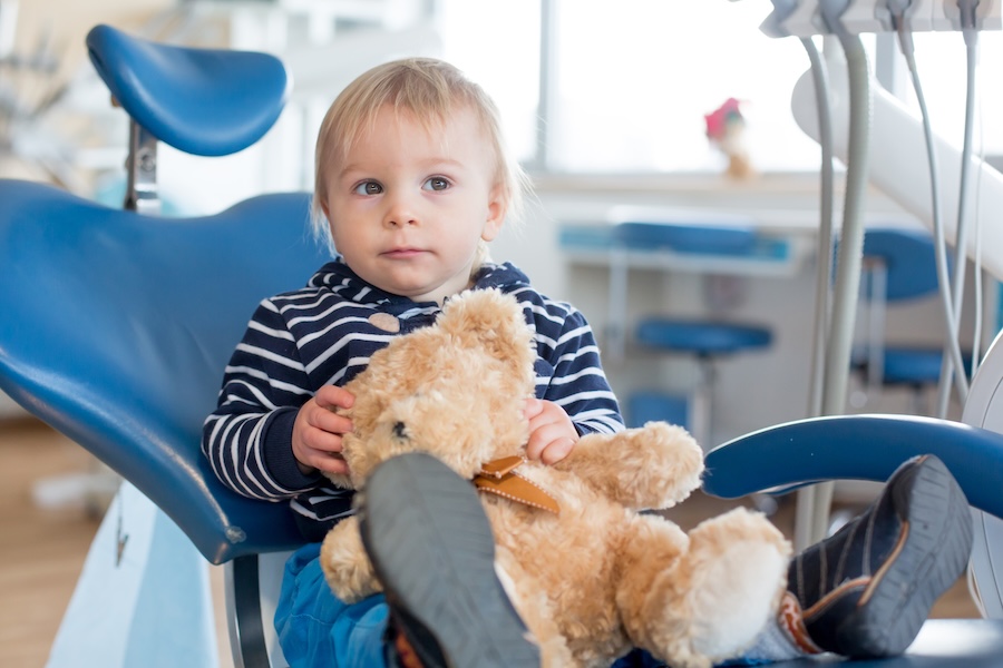 baby at first dental visit for a checkup at the dentist
